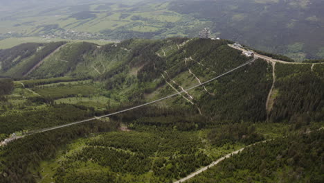 Longest-suspension-footbridge-in-world-above-valley-in-Czechia,-drone