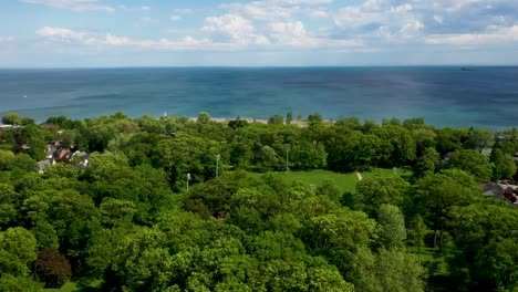 Flying-over-a-sunny-summer-park-in-Toronto-right-on-the-lakeshore-of-Lake-Ontario