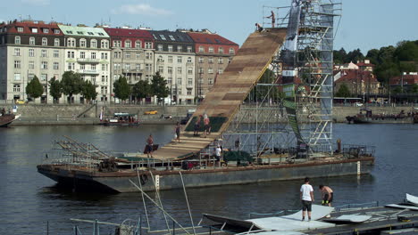 Workers-on-a-pontoon-build-a-ramp-on-the-Vltava-River-for-an-extreme-sports-show