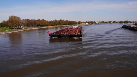 Aerial-Circle-Dolly-Around-Forward-Bow-Of-Veerhaven-Pushing-Barges-Along-Oude-Maas