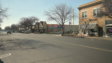 Cars-travel-through-town-center-in-Kingsburg,-California,-USA