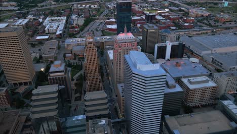 Aerial-view-around-tall-office-buildings-in-Oklahoma-city,-gloomy-evening-in-USA---circling,-drone-shot
