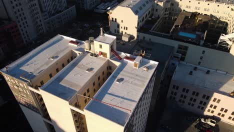 Aerial-view-around-the-Haunted-Cecil-hotel,-sunny-evening-in-Los-Angeles,-USA---high-angle,-orbit,-drone-shot