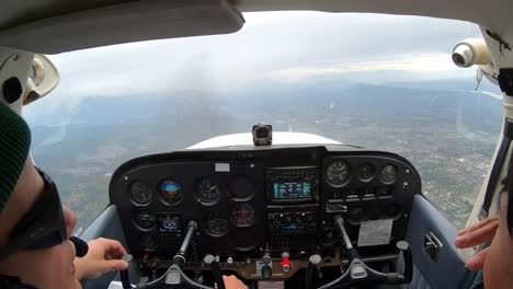 Pilots-In-The-Cockpit-Navigating-Cessna-Plane,-Approaching-To-Land-At-The-Airport