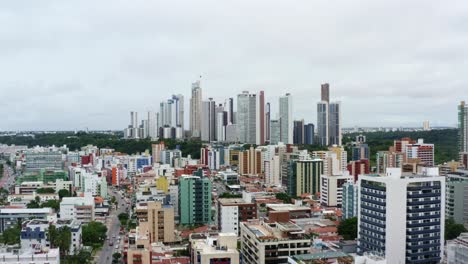 Aerial-drone-shot-of-the-cityscape-of-the-colorful-tropical-beach-capital-city-of-Joao-Pessoa-in-Paraiba,-Brazil-from-the-Tambaú-neighborhood-on-an-overcast-morning