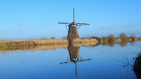 Traditional-windmill-at-Kinderdijk-with-a-beautiful-reflection-is-slowly-bobbling-water