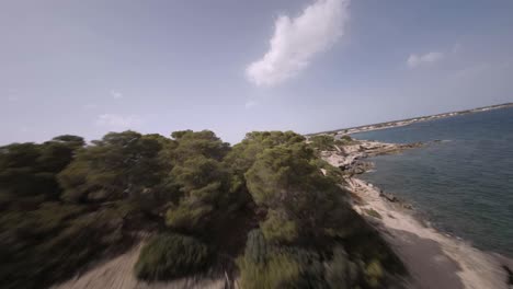 FPV-drone-shot-over-luxury-cottage-along-rocky-beaches-in-Faro-de-s'Estalella,-Mallorca,-Balearic-Islands,-Spain-on-a-sunny-day