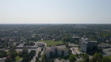 Hazy-summer-day-from-a-drone-flying-over-London,-Ontario
