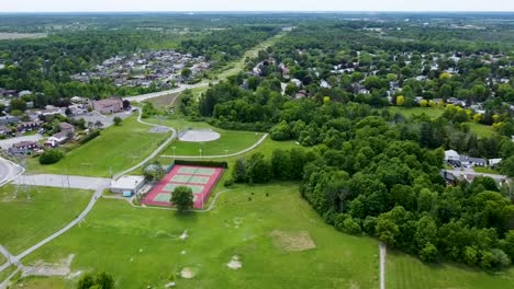 Aerial-shot-of-tennis-courts,-soccer-field-and-a-baseball-diamond-on-a-summer-day-in-Nepean