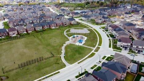 Drone-flying-towards-a-Kleinburg-neighborhood-park-and-playground-in-spring