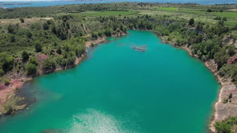Turquoise-small-lake-water-aerial-overhead-view,-near-Montpellier-in-France