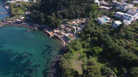 Wide-angle-drone-short-orbiting-a-resort-on-the-coast-of-the-tropical-island-of-Ischia-located-in-Italy