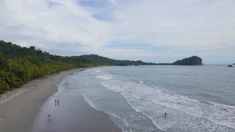 The-coastlines,-beaches-and-lush-vegetation-of-the-Manuel-Antonio-national-park-in-Costa-Rica,-with-people-relaxing-and-swimming