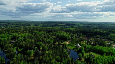 Backwards-drone-dolley-shot-of-a-holiday-park-surrounded-by-trees-in-Latvia