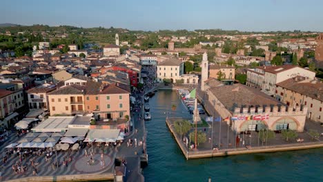 Aerial-shot-approaching-a-small-harbour-in-Lazise-Italy