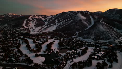 Backwards-drone-dolley-shot-of-colorful-sky-during-a-sunset-in-Park-City-in-Utah