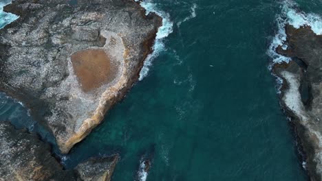 Top-down-aerial-view-of-rocky-islands-off-California's-coast,-home-to-many-seabirds