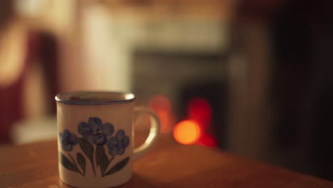 Isolated-Mug-On-Wooden-Table-With-Bokeh-Fireplace