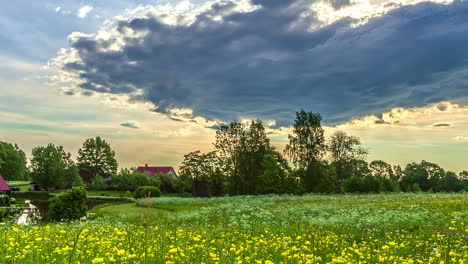 Timelapse-of-Flowery-Valley-with-Houses-and-Cloudy-Sky