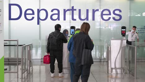 Flight-passengers-go-through-security-screenings-at-the-departure-hall-in-Hong-Kong-international-airport