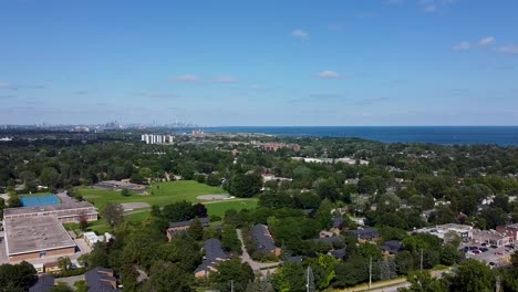Drone-flying-over-a-school-and-neighboring-field-near-Lake-Ontario-in-Mississauga