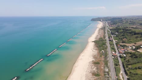 Wide-angle-drone-shot-of-the-beautiful-coastline-off-the-coast-of-the-Adriatic-Sea-located-in-the-region-of-Abruzzo,-Italy-during-a-hot-summer-day