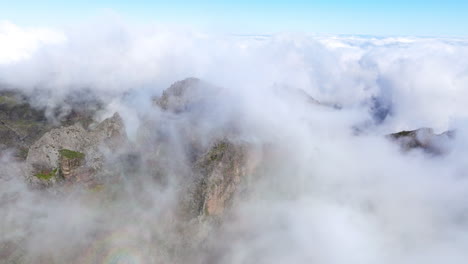 Clouds-In-The-Mountain-Peak-Pico-do-Arieiro-In-Highlands-Of-Madeira,-Portugal---aerial-drone-shot