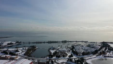 Drone-flying-around-a-frozen-harbor-on-Lake-Ontario-in-Mississauga