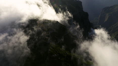 Aerial-Drone-View-Of-Pico-do-Areeiro-Mountain-Peaks-Covered-With-Misty-Clouds-In-Madeira-Islands,-Portugal