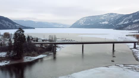 Winter-Wonderland:-Aerial-View-of-the-Bridge-over-South-Thompson-River-and-Little-Shuswap-Lake-in-Chase,-BC
