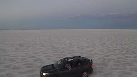 SUV-driving-along-bonneville-salt-flats-with-windows-down