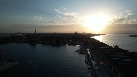 Sun-Rises-Above-Venice-Island,-Italy,-Bridge-and-Calm-Blue-Sea-of-Italian-City-of-Canals,-Aerial-Drone-Flying-above-Idyllic-Venetian-Lagoon,-Sailing-Boats