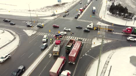 Fire-truck-responds-to-a-car-crash,-snowy,-winter