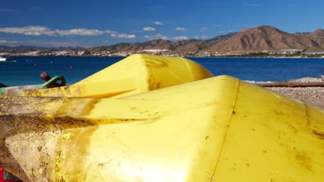 Panning-right-over-yellow-buoys-in-La-Azohía-beach,-Murcia,-Spain