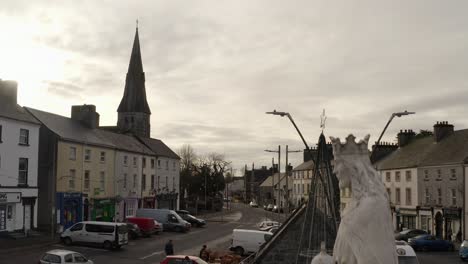 Ascending-drone-shot-over-a-statue-of-Jesus-in-Gort,-Ireland