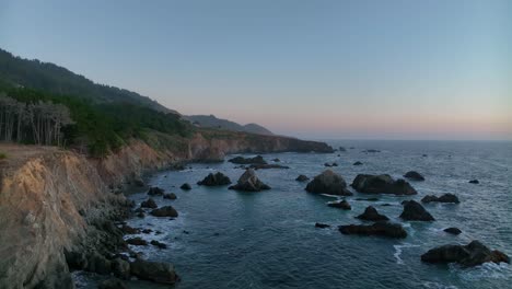 Drone-shot-of-California's-rocky-northern-coastline-at-sunset