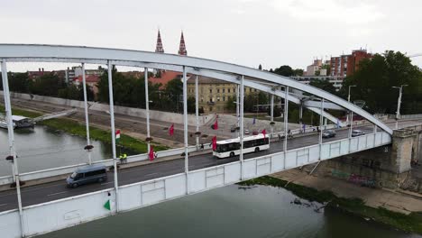 Cars,-pedestrians-cross-Belvárosi-Bridge-over-Tisza-River,-Szeged,-Hungary
