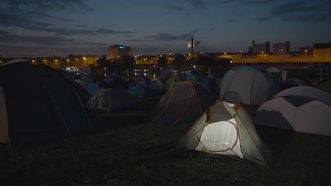Tents-in-field-near-small-lake,-Szeged,-Hungary