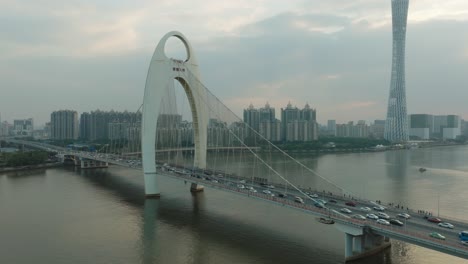 Traffic-on-Liede-Bridge-over-Zhujiang-river,-aerial-view-on-Canton-tower,-Guangzhou,-China