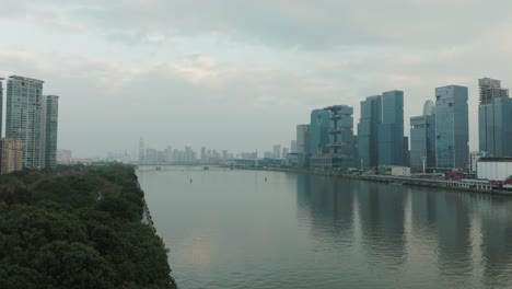 Guangzhou-city-skyline-on-overcast-day,-aerial-view-over-Pearl-River