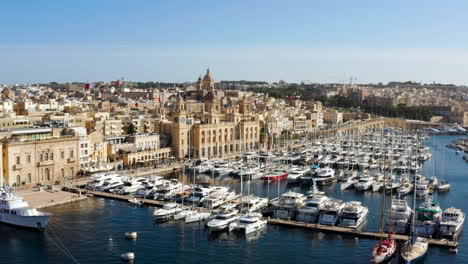 Birgu-Malta-Waterfront-With-Yachts-Moored-In-The-Marina---aerial-drone-shot