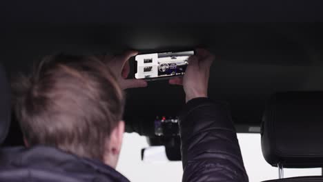 Car-technician-taking-a-picture-of-the-dashboard-and-steering-wheel-of-the-Mercedes-car-interior