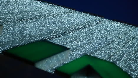 Close-up-vertical-video-of-shopping-mall-entrance-at-night-with-Xmas-decorations
