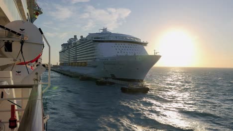 Huge-cruise-ship-moored-to-pier-in-Caribbean-port-at-sunset