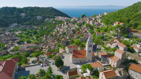 Aerial-View-Over-Village-Church-Tower-On-Island-Lastovo-In-Croatia---drone-shot