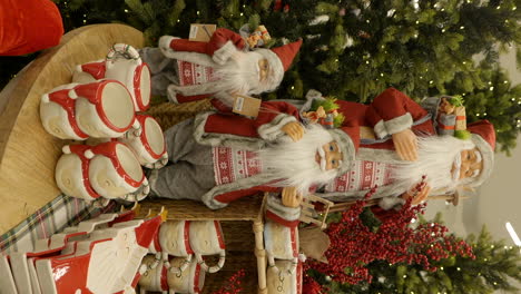 Vertical-shopping-mall-xmas-gifts-decorations,-cups,-trees,-and-Santa-puppets