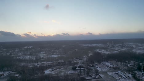 An-aerial-shot-of-a-winter-sunset-with-large-clouds-on-the-horizon
