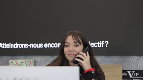 Business-woman-taking-a-phone-call-in-modern-office-in-France