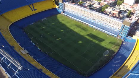 Aerial-orbit-shot-Stadium-with-Boca-Junior-Soccer-Players-during-training-in-sunlight