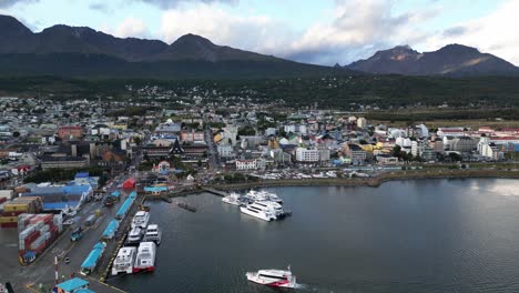 Ushuaia-City-and-Sea-Port-in-Patagonian-Gateway-Route,-Seascape-of-Magellan-Strait,-Ships,-Containers-and-Patagonia-Mountain-Range-Landscape
